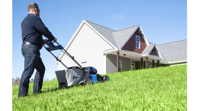 person using Kobalt 80V 21-inch Cordless Lawn Mower