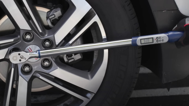 Quinn torque wrench on car tire