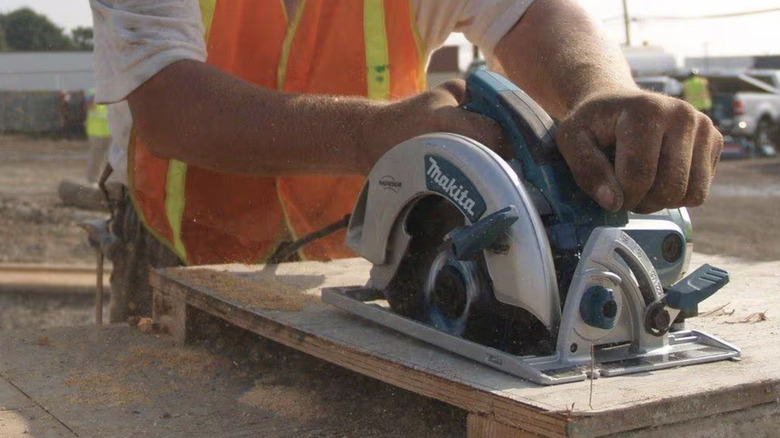 Circular saw cutting through wood