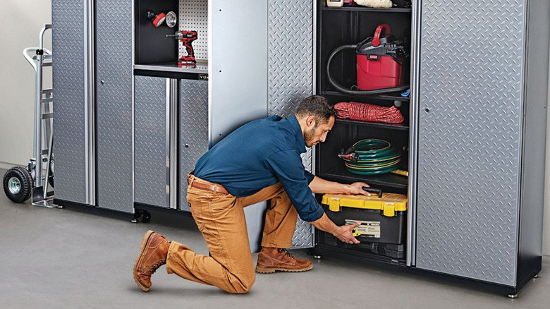 person in front of yukon garage cabinet