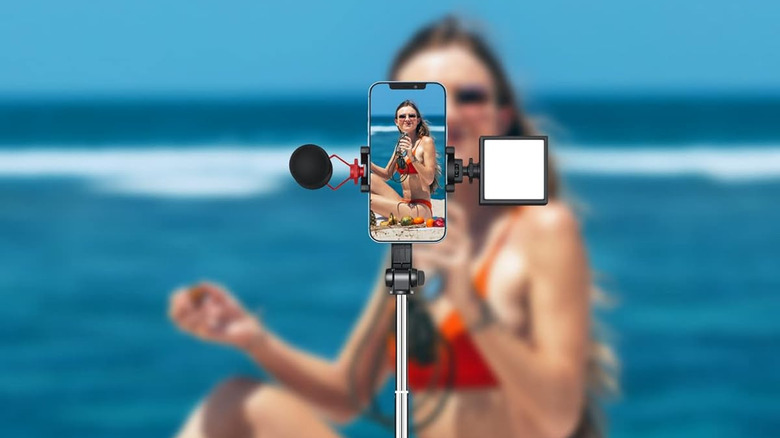 Phone recording woman on beach