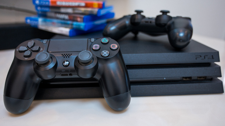 PlayStation 4 with two DualShock controllers and games