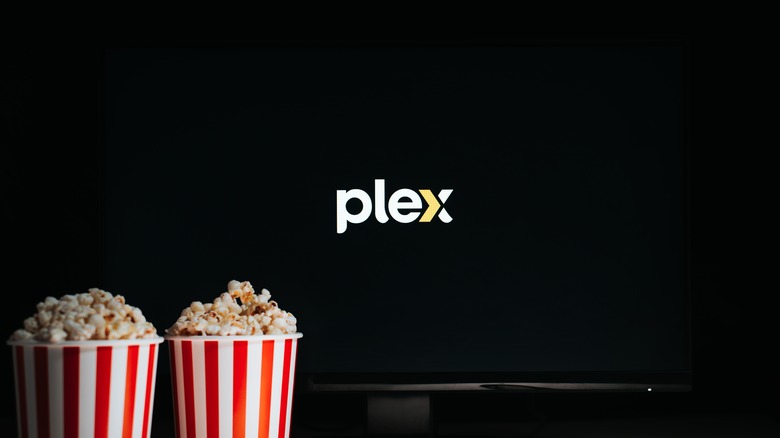 Two buckets of popcorn in front of TV with Plex logo