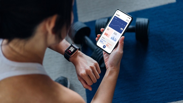 Person using a phone and smartwatch to track their fitness