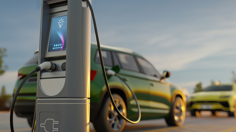 green EV at a charging station