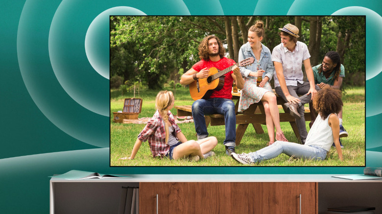 Hisense TV with people sitting in park on the screen