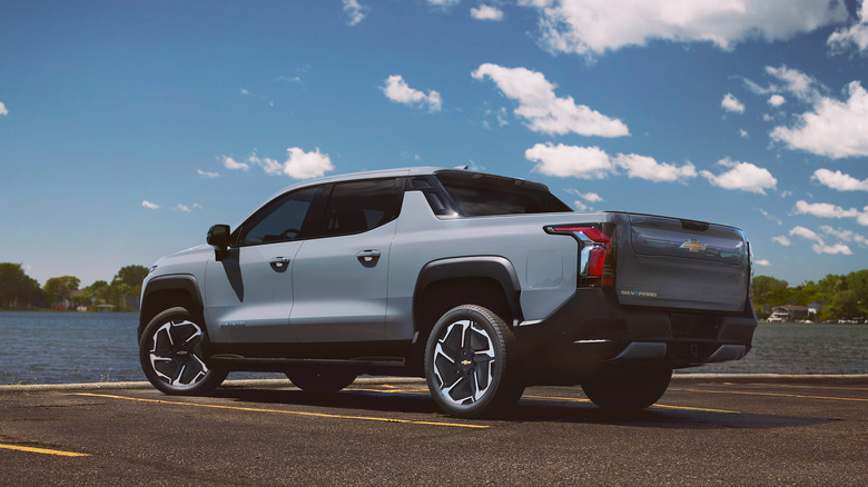 silver Chevrolet Silverado EV parked by waterfront