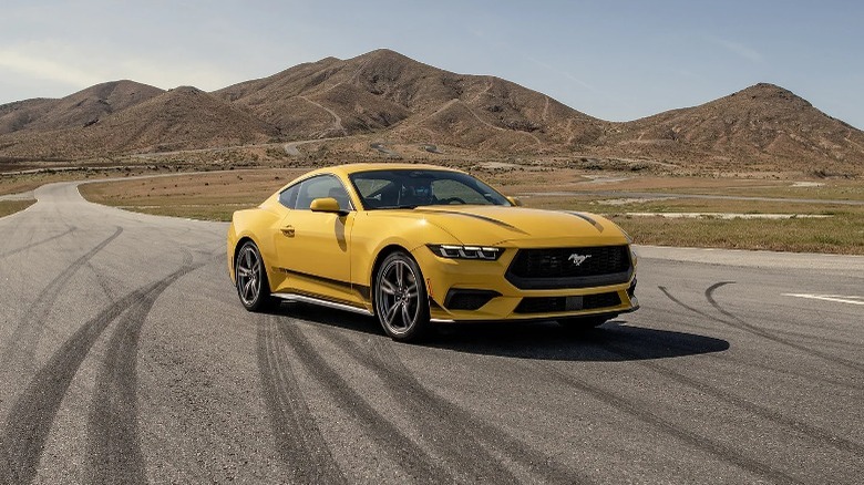 Yellow Ford Mustang parked on a road