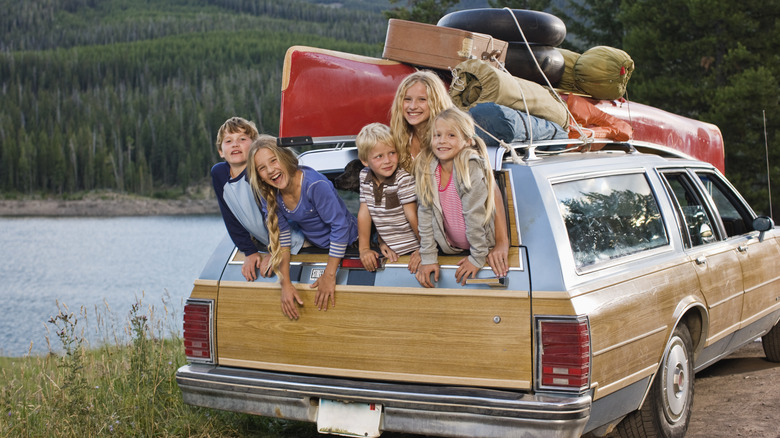 Kids hanging out the back of station wagon