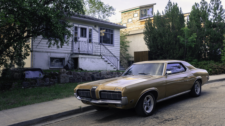 Vintage gold Mercury Cougar parked