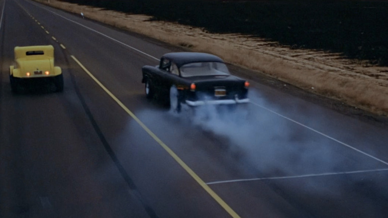 Yellow 1932 Ford Coupe and black1955 Chevy 150 drag racing in American Graffiti