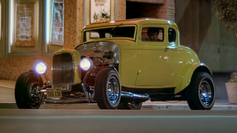 Yellow 1932 Ford Deuce Coupe from American Graffiti parked on street at night