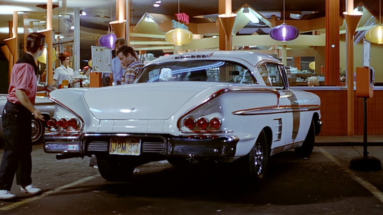 White 1958 Chevy Impala parked outside diner in American Graffiti