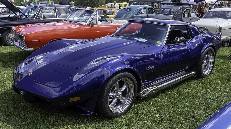 Blue Corvette Stingray with side pipes parked at car show