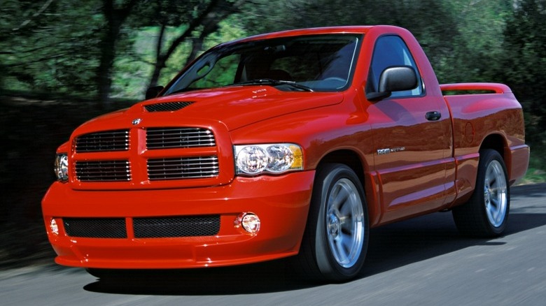 Close-up shot of a 2004 Dodge Ram SRT-10 driving on a road with trees in the background