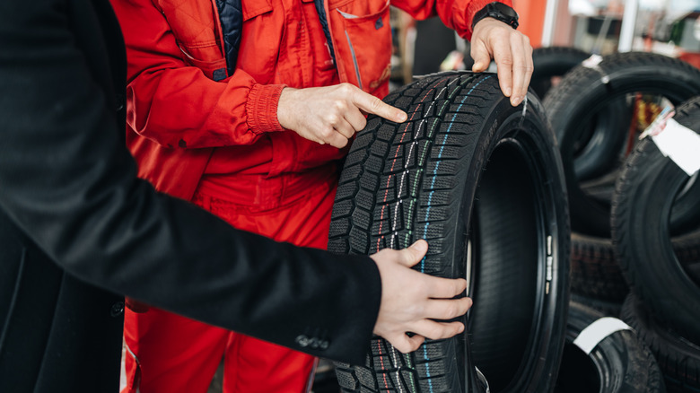 Inspecting new tires with a mechanic