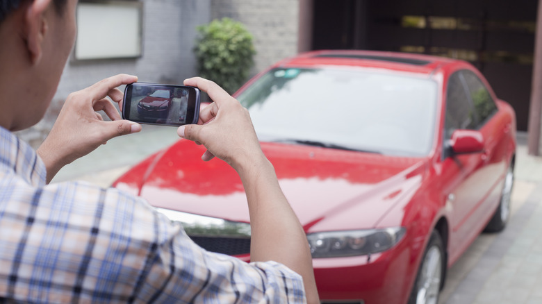 Person photographs a car