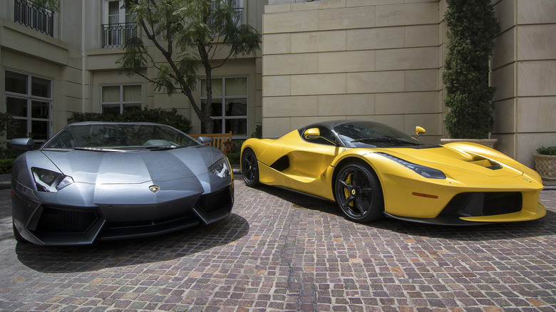 Lamborghini Aventador and a Ferrari LaFerrari parked in driveway