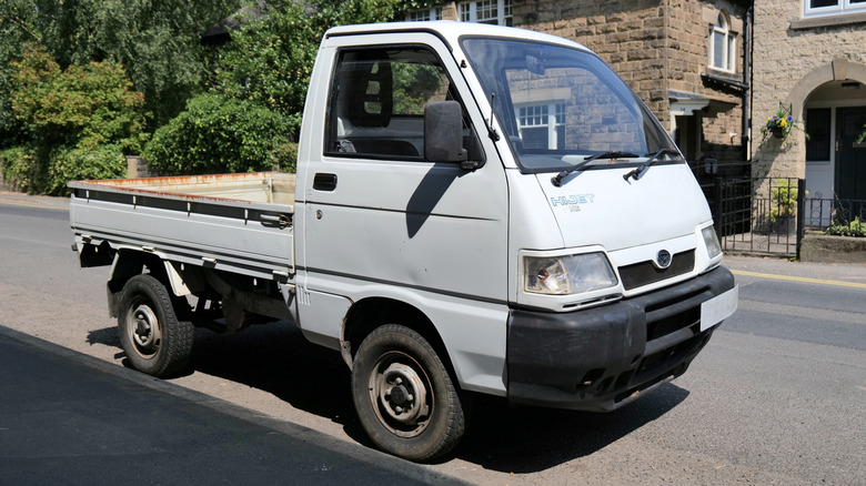 White Daihatsu Hi-Jet on the road