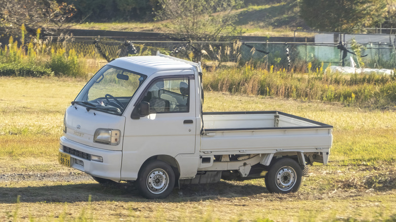 White Daihatsu Hi-Jet in field in Japan