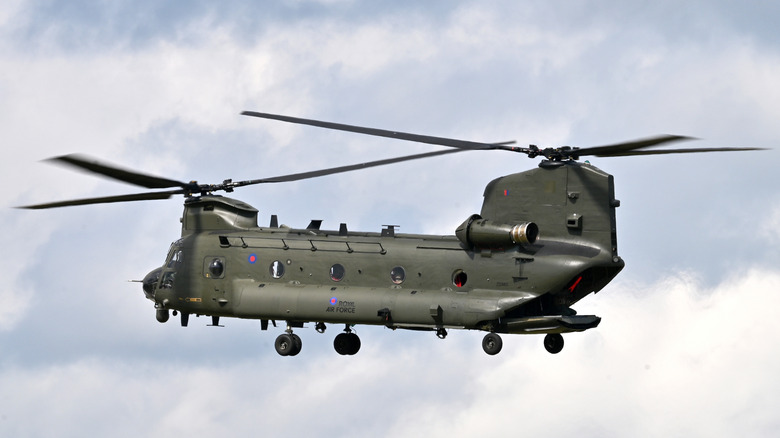 0A CH-47 Chinook hovering in partly cloudy sky