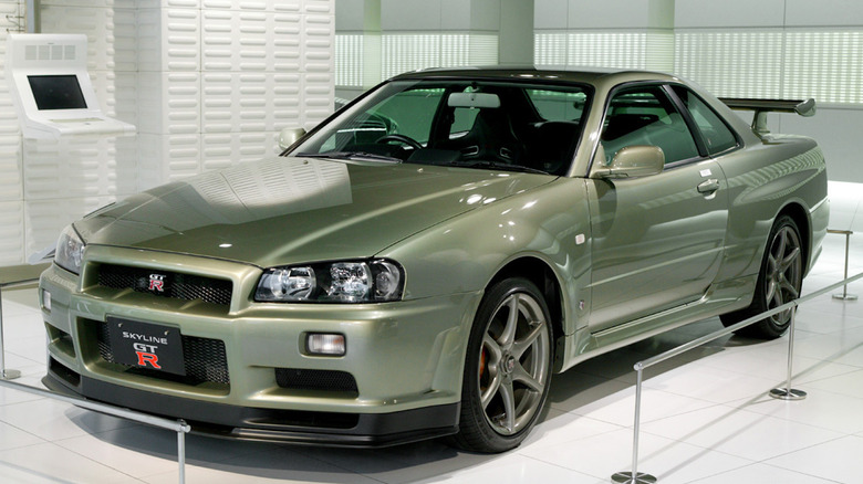 metallic green Nissan GT-R Nismo parked in white garage