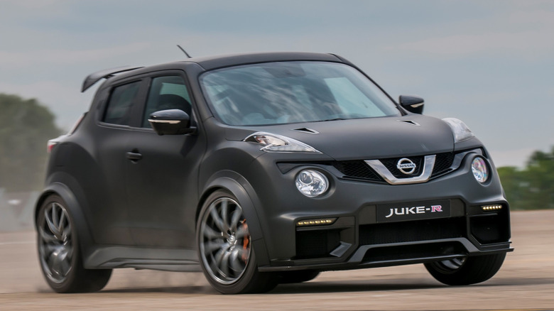 dark grey Nissan Juke-R taking turn on unpaved surface