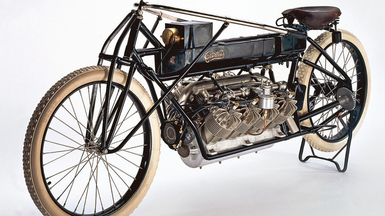 Glenn Curtiss-built V8-powered motorcycle from early 20th Century on stand against white background