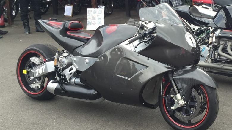 Eisernberg V8 with full fairing in gunmetal grey parked on asphalt next to unfaired version