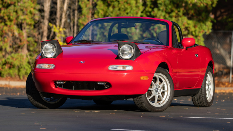 Red Miata smiling with popup headlights