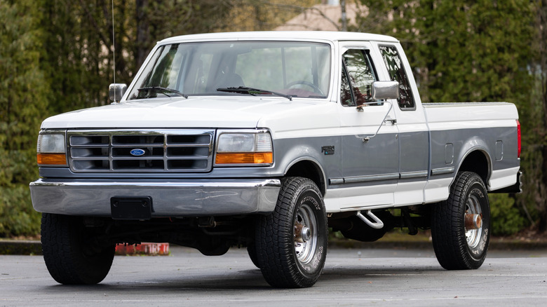 A 1990s Ford pickup truck parked on the street