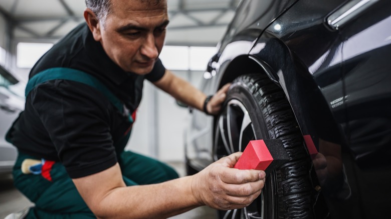 detailer applying tire shine