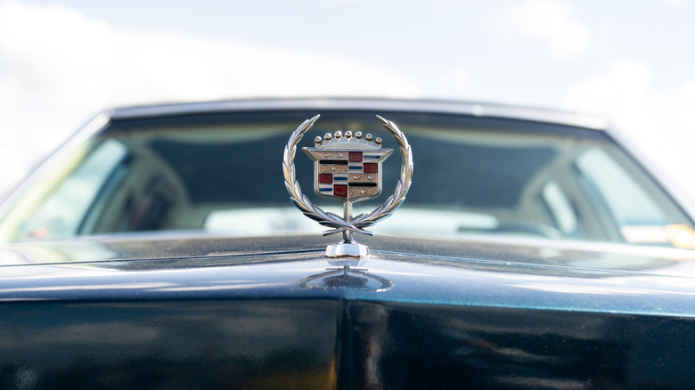 Cadillac hood ornament logo on front of car