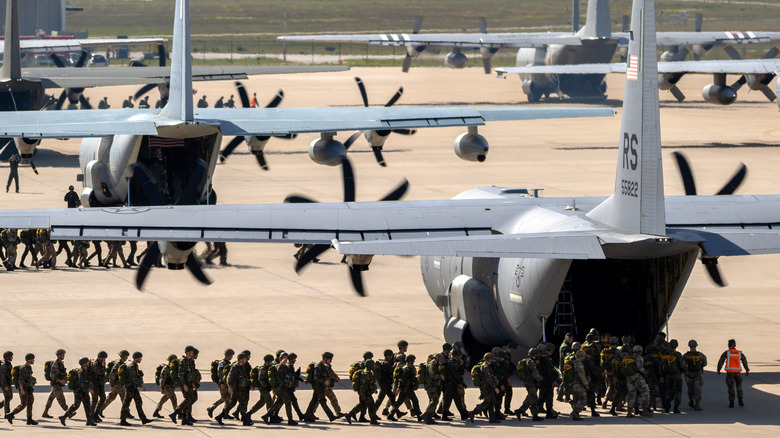 Soldiers loading onto C-130s
