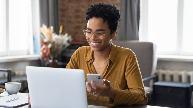 woman smiling using laptop