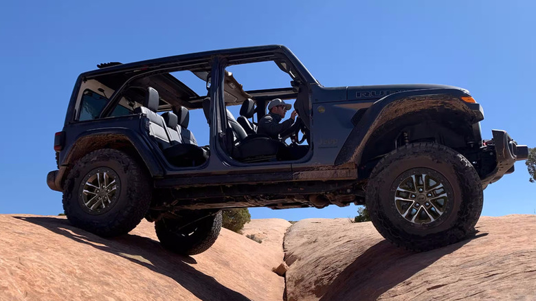 2024 Jeep Wrangler driving over rocky area