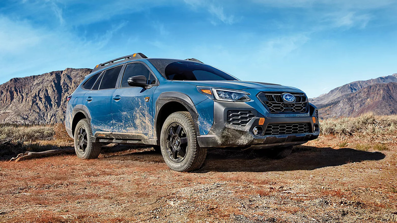 2025 Subaru Outback covered in mud parked off-road