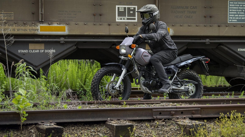 person riding yamaha tw200 motorcycle