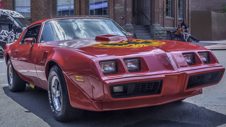 Red Pontiac Firebird with black and yellow emblem