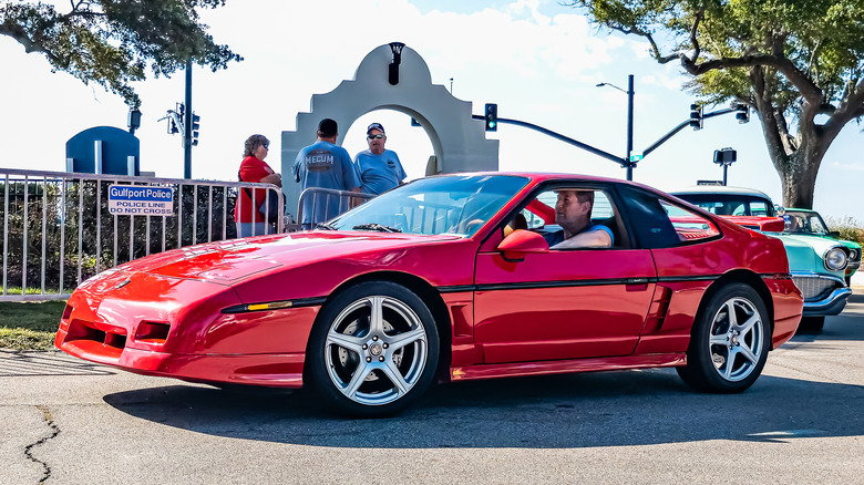 Red Pontiac Fiero GT driving