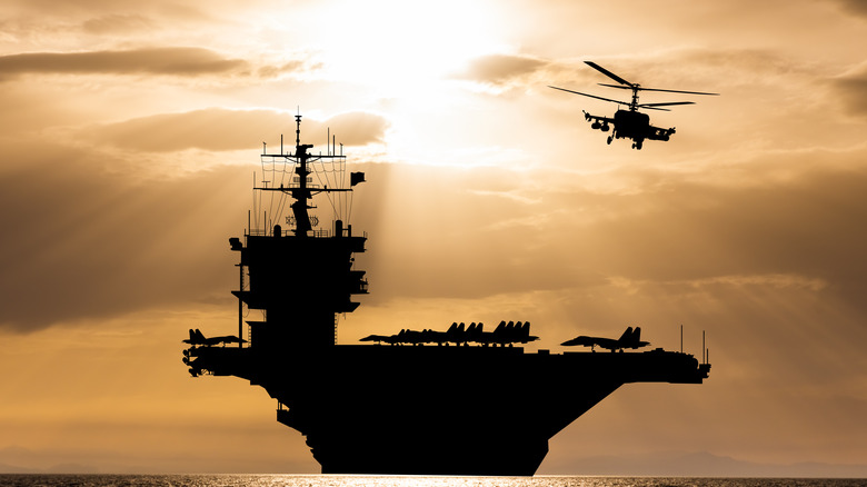 Aircraft carrier silhouette at sunset