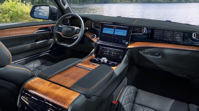 Jeep Grand Wagoneer interior showing digital instruments and wood-grain dashboard