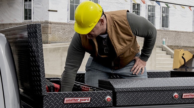 Worker reaching into toolbox