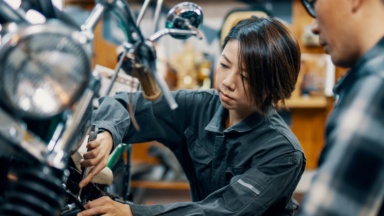 People examining motorcycle