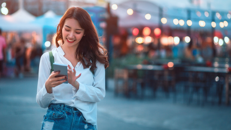 woman smiling phone vacation