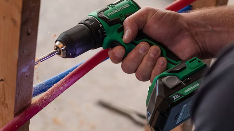 person using metabo drill