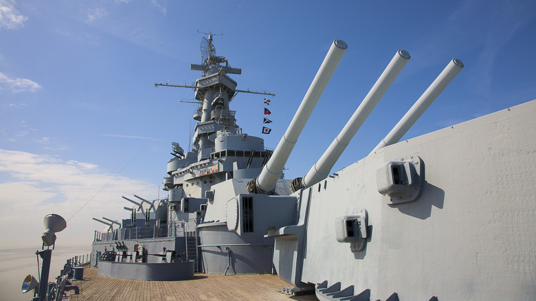 The main deck of a warship, highlighting its three cannons