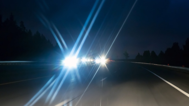 Oncoming cars on highway at night