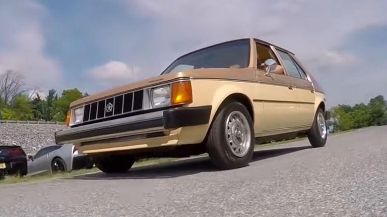 1985 Plymouth Horizon In Two-Tone Brown Driving Down The Road