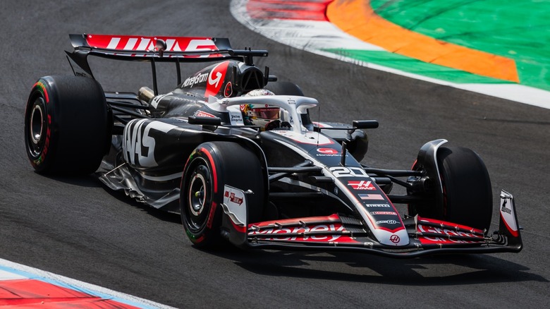 Formula 1 cars racing on a night track